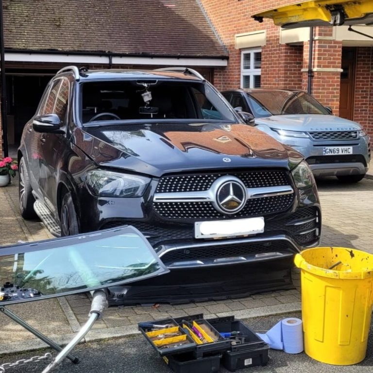 A black Mercedes SUV parked in front of a house, showcasing Epic Windscreens' expertise in windscreen replacement.