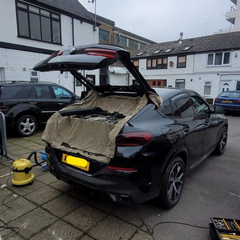 A BMW SUV parked on the street in London with its tailgate open, showcasing the heated rear window replacement service by Epic Windscreens.